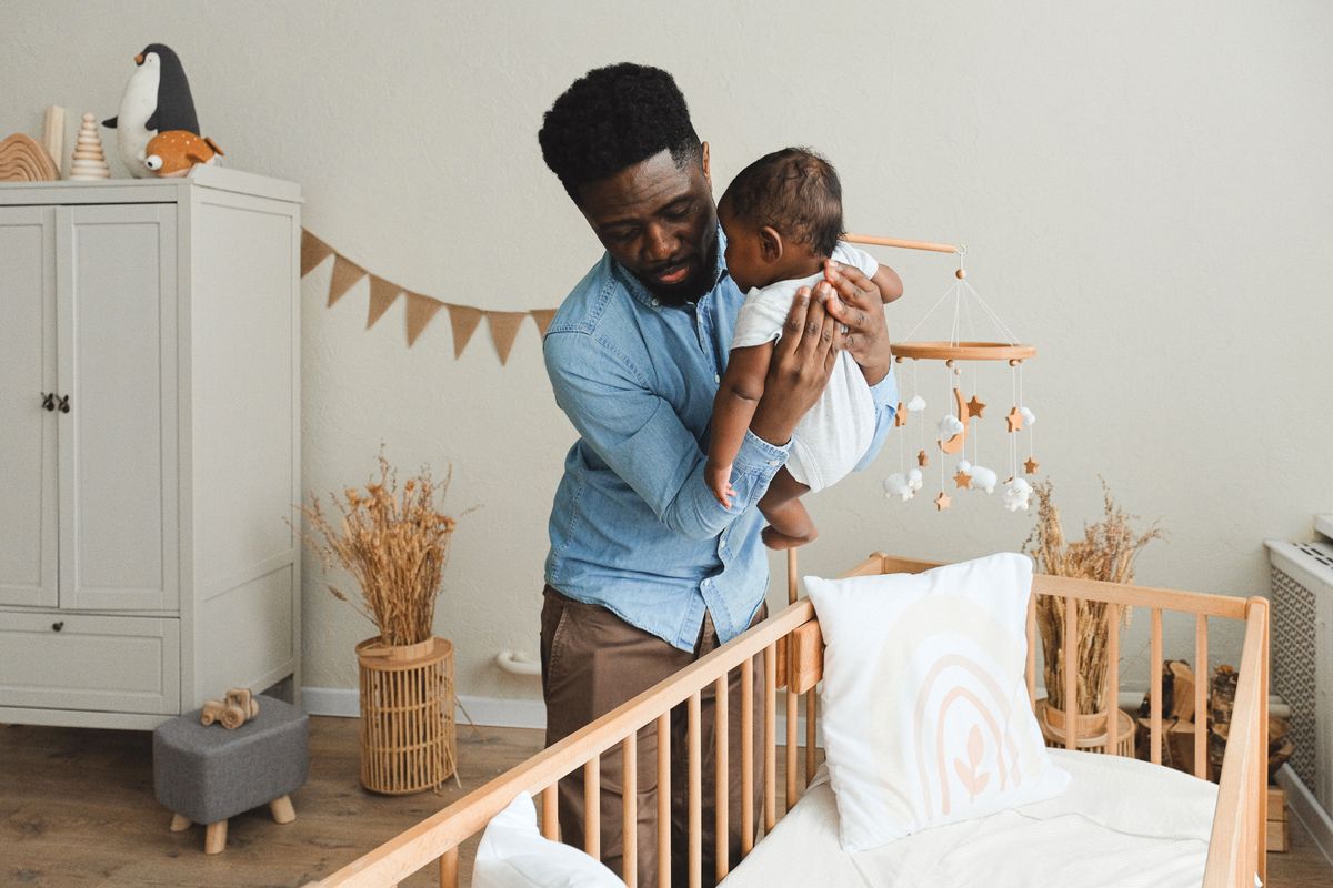 Parent safely settling a baby in a childproofed room