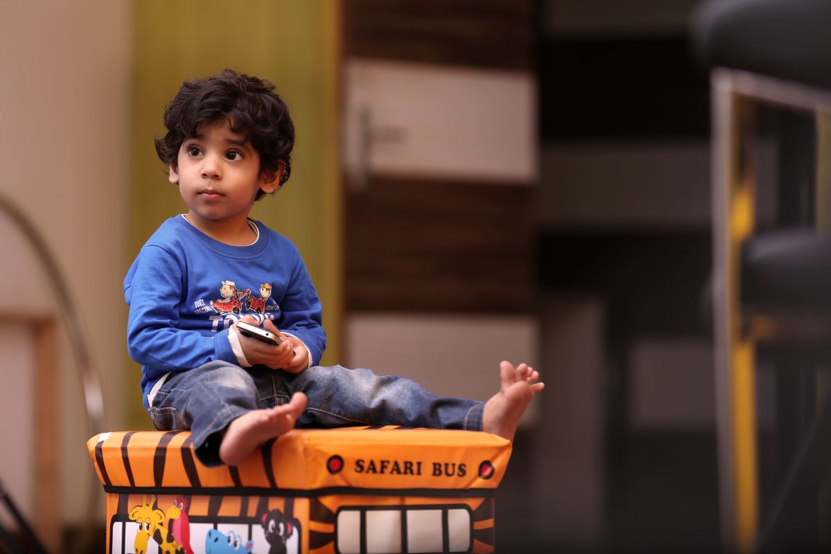 Child playing with a ride-on vehicle toy