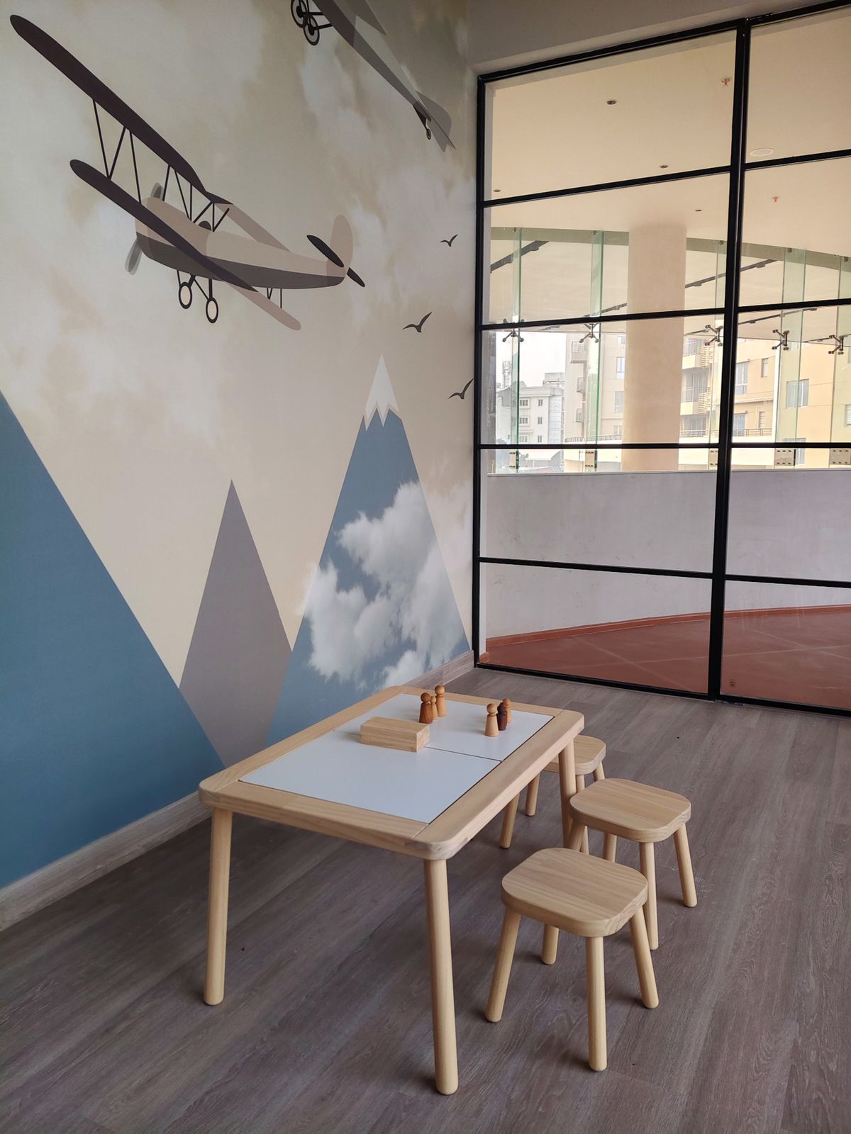 A calm, Montessori-style room with low wooden furniture