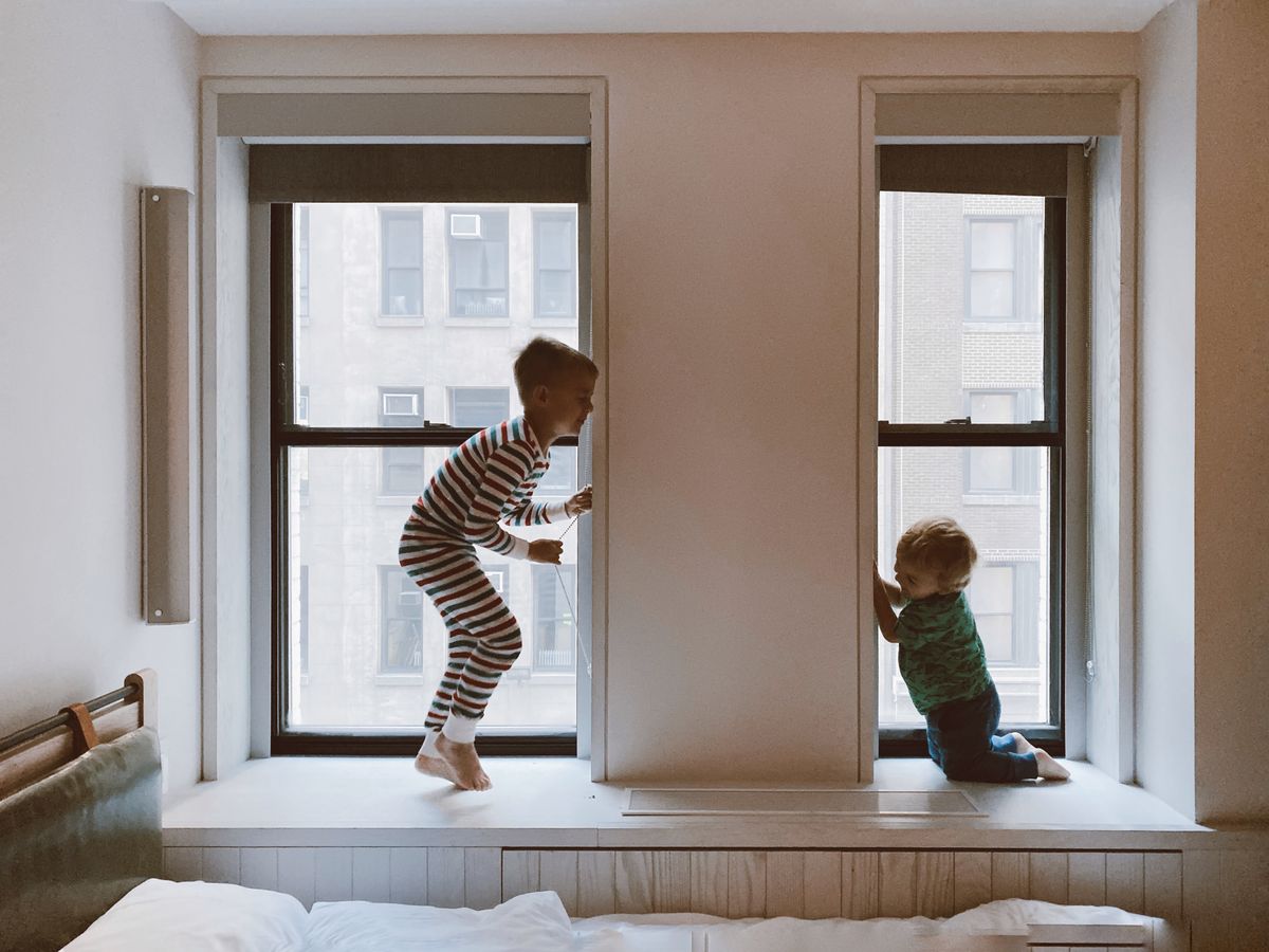 Children by a bright window in a seasonally refreshed room