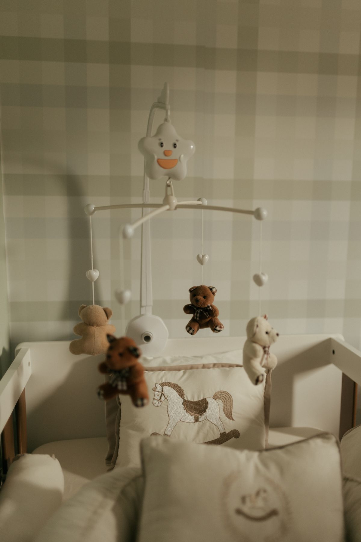 Cozy nursery corner with a crib and soft mobile