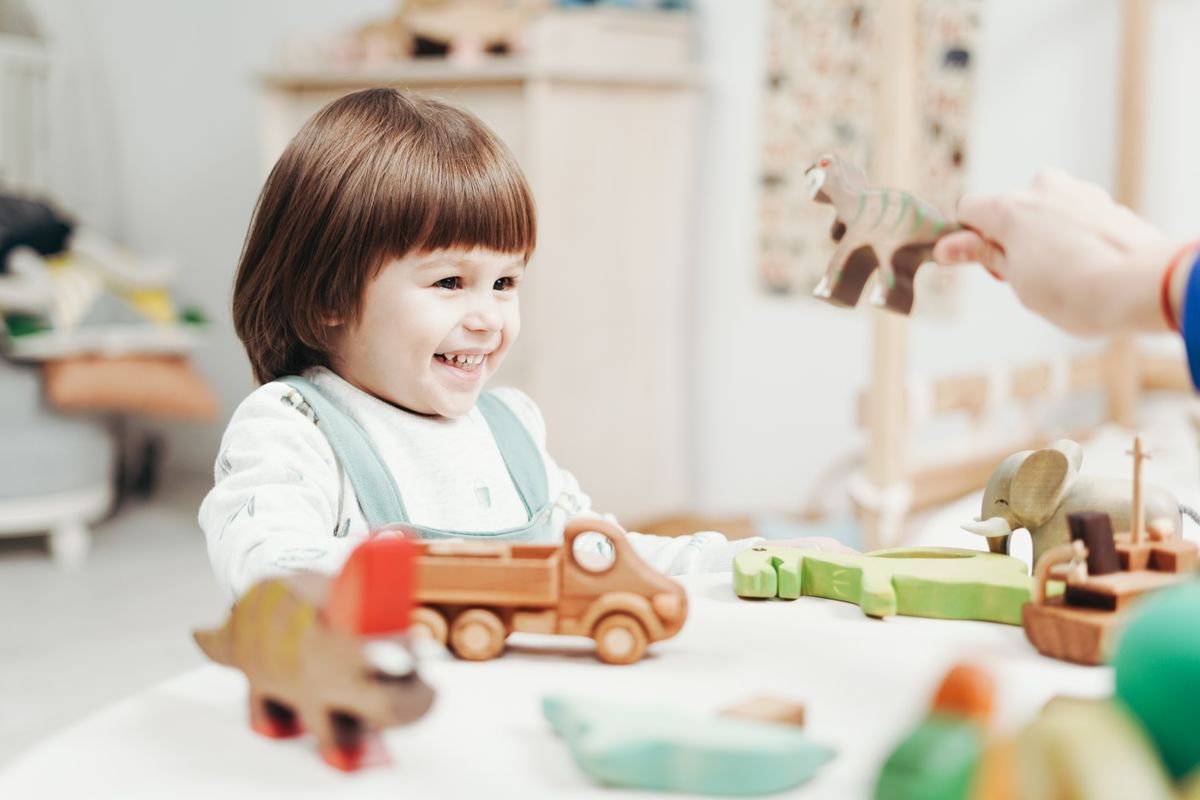 Child happily playing with toys, screen-free