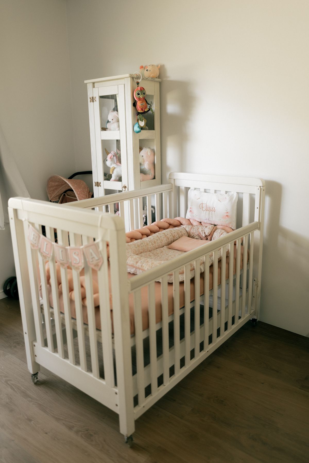 Cozy baby nursery with a white crib and soft toys