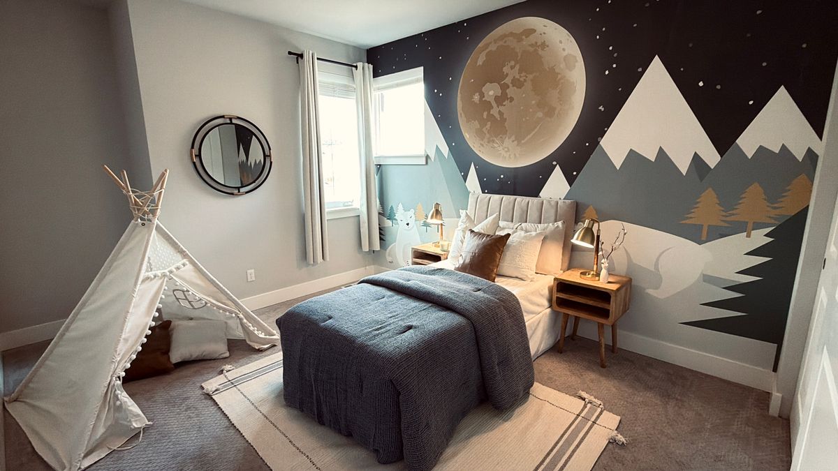Kids bedroom with soft, warm lighting and a wall mural