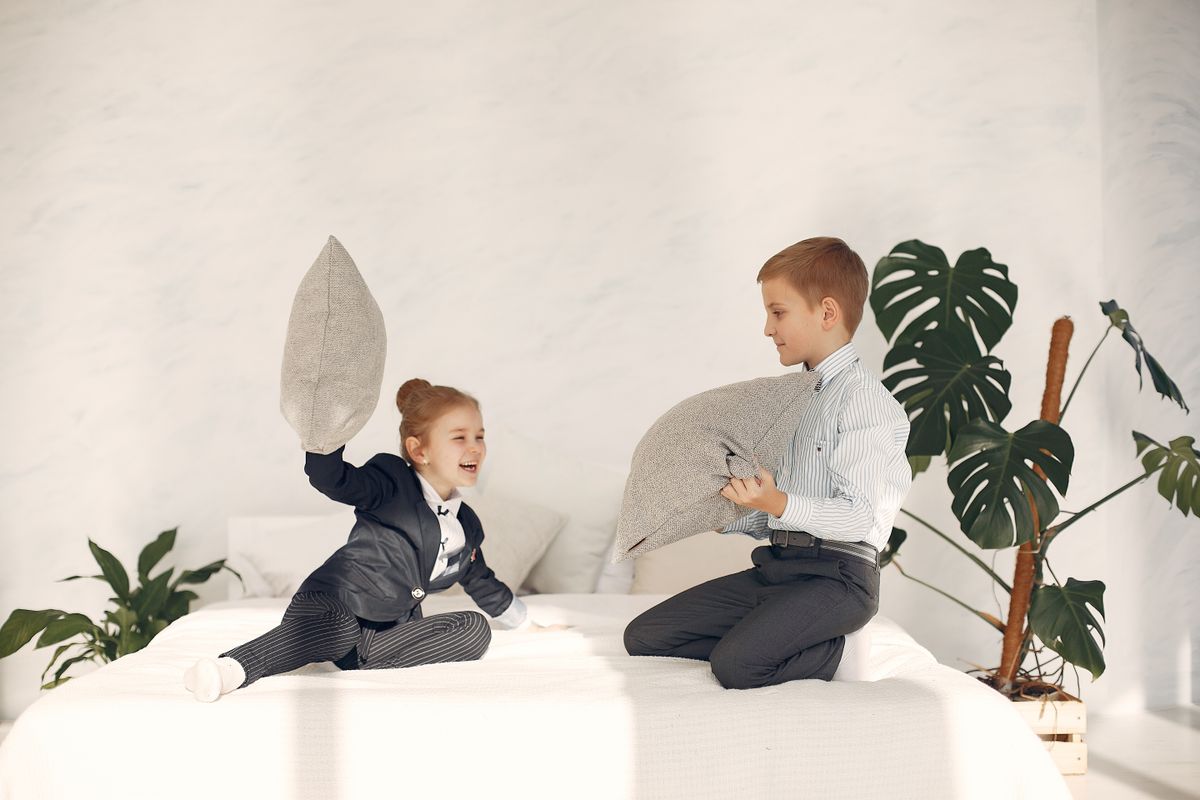 Active, sporty kids having fun in their room
