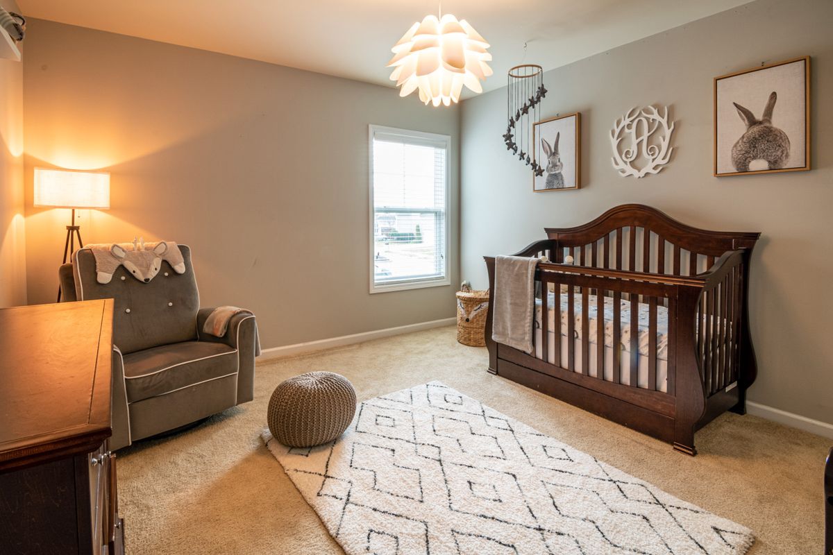Kids room with natural light and a wooden crib by the window