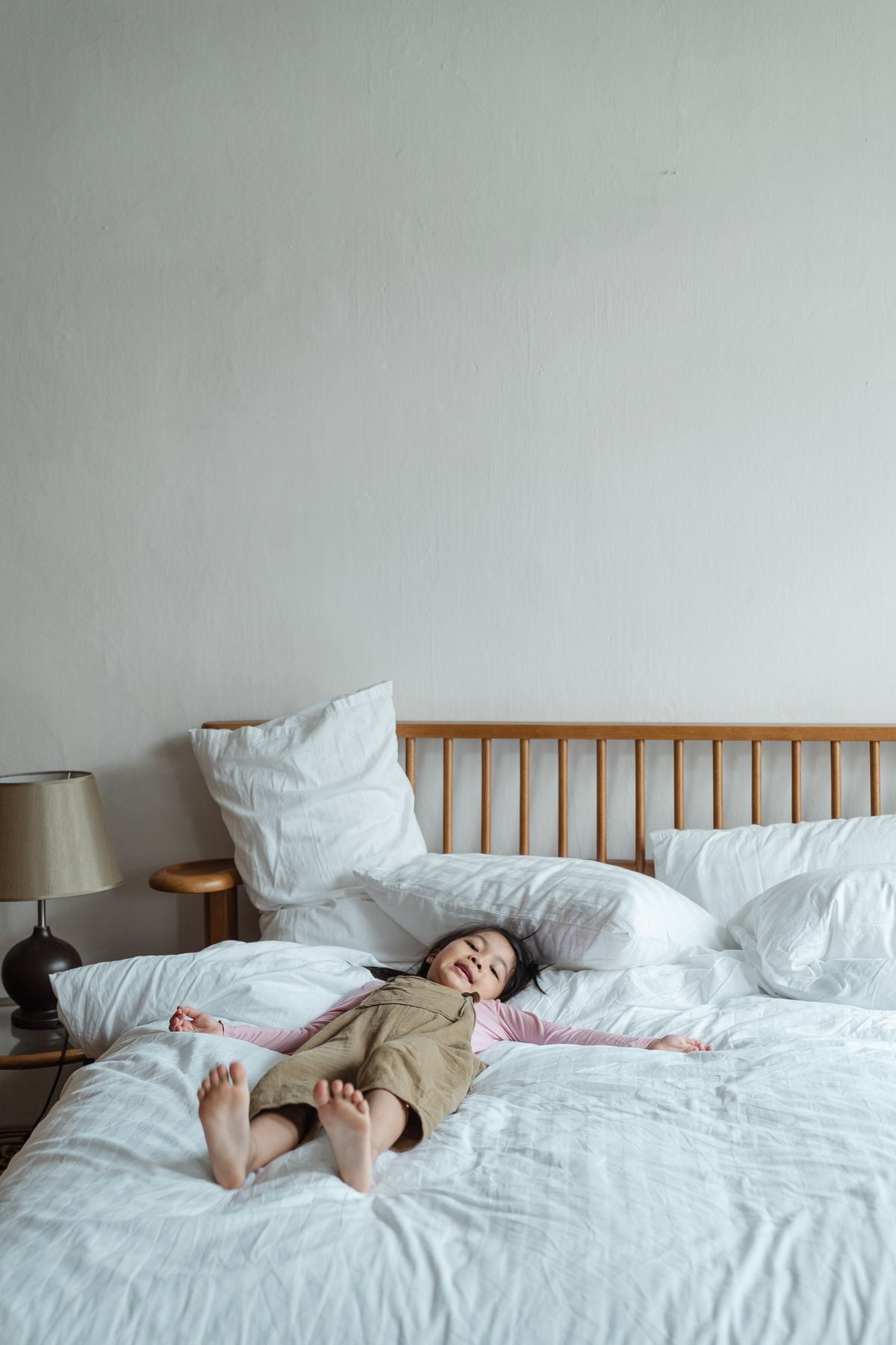 Child resting on a bed during naptime