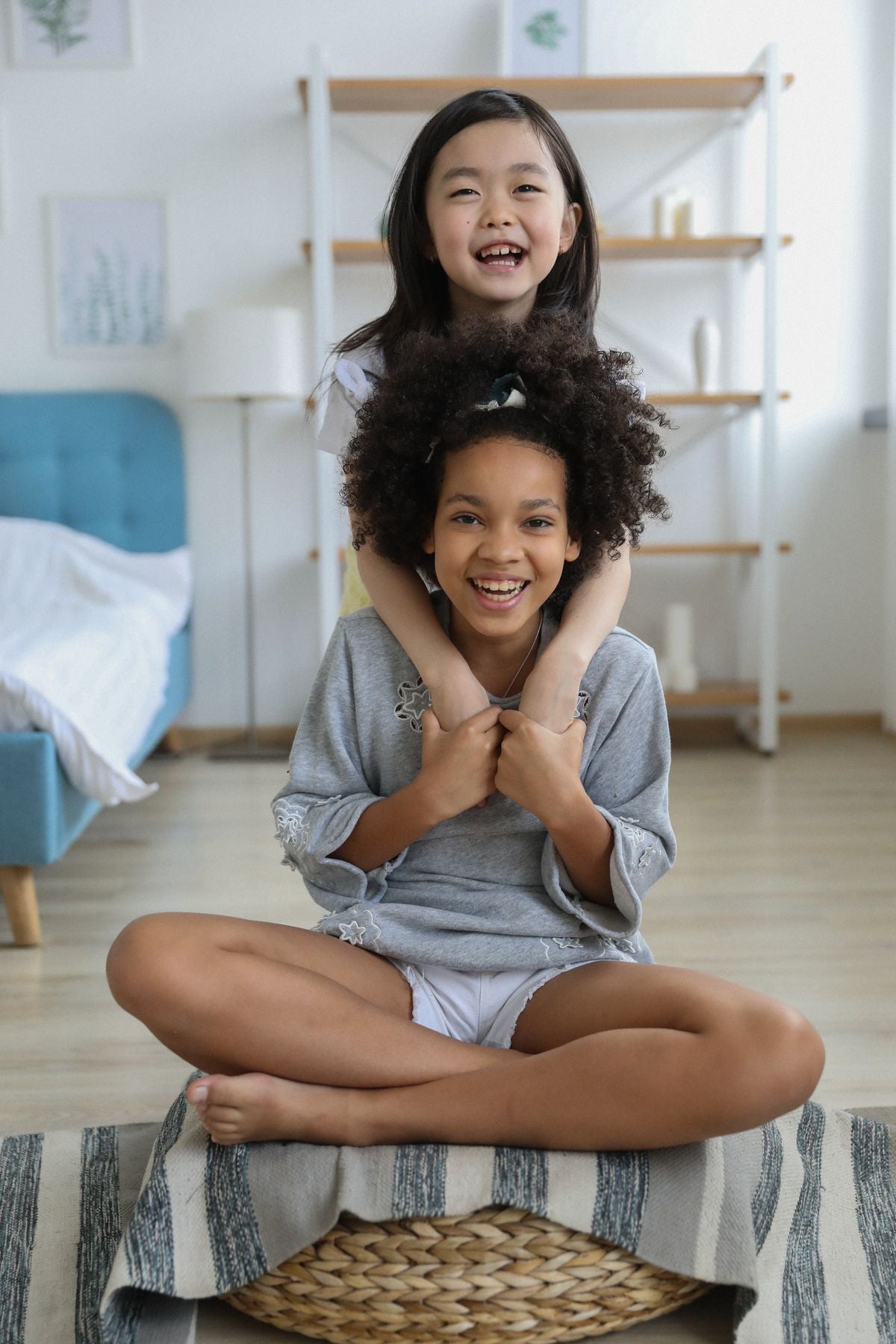 Two children hugging in a cozy room