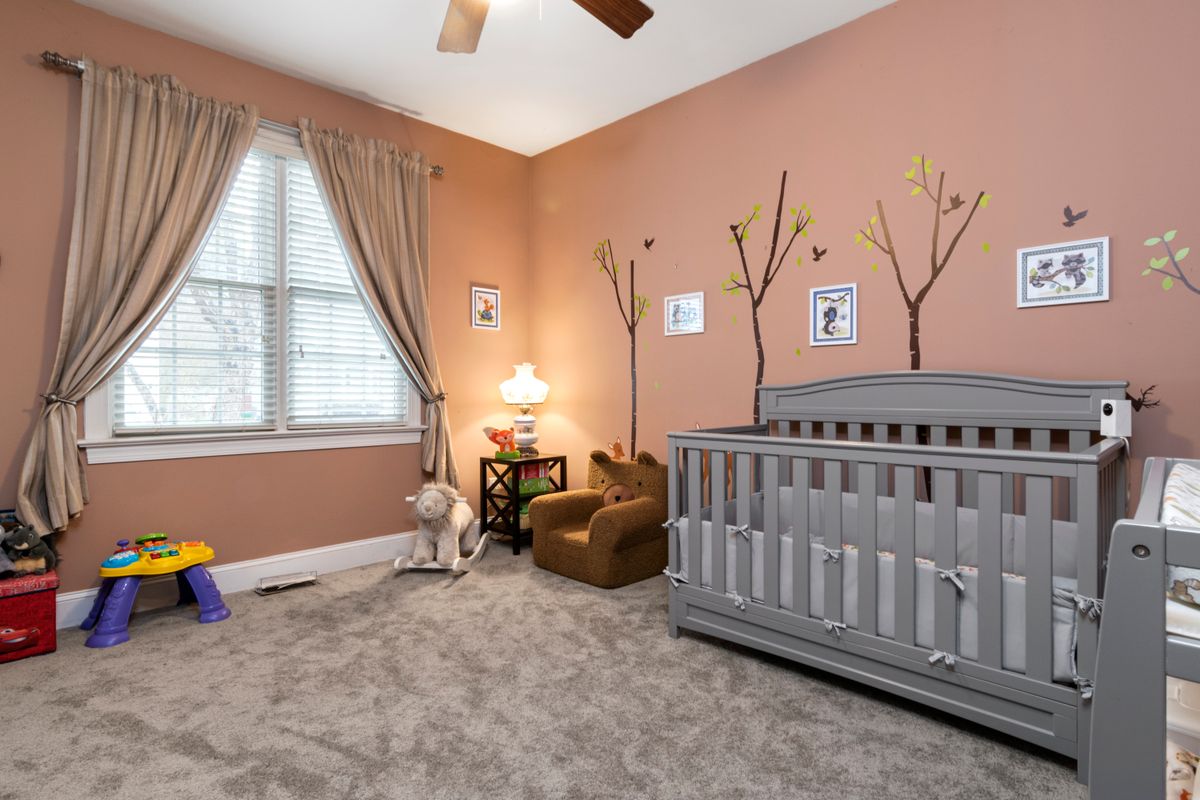 Child's bedroom with a personalized name above the bed