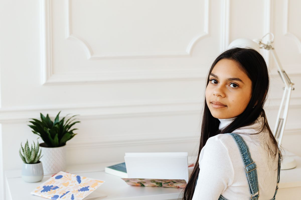 Child studying at a tidy homework desk