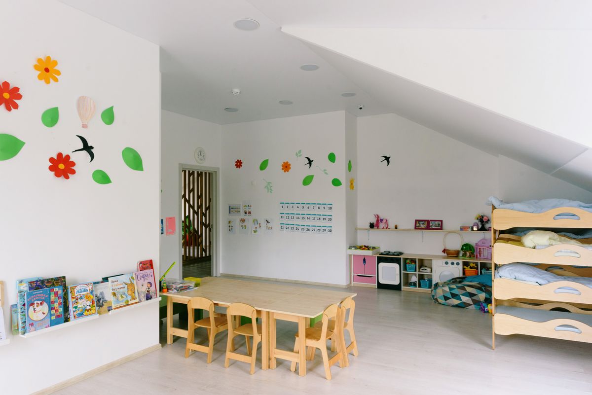 Tidy kids room with wooden storage furniture